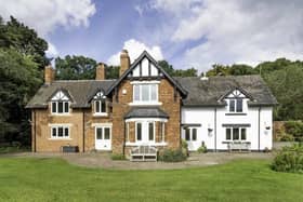 A front view of the sizeable cottage-style home within Rossington Hall Gardens.