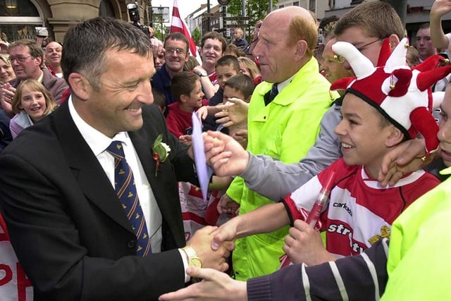 Rovers boss Dave Penney shakes the hands of young fans outside the Mansion House