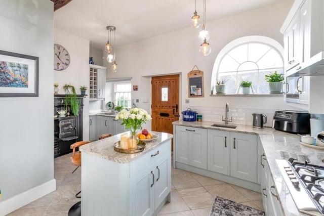 The stunning kitchen with central island and breakfast bar.