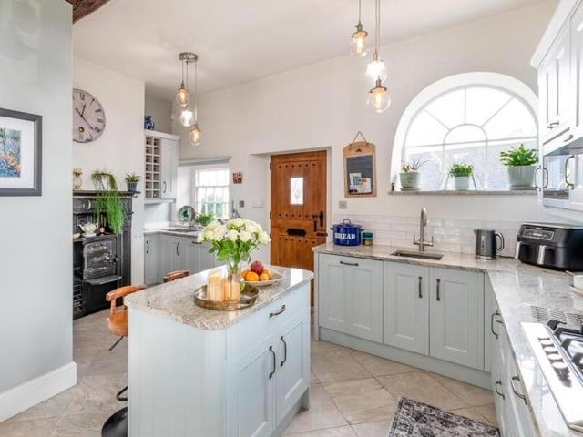 The stunning kitchen with central island and breakfast bar.