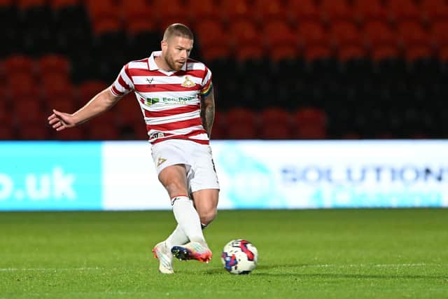 Doncaster Rovers captain Adam Clayton has left the club to join their League Two play-off rivals Bradford City.