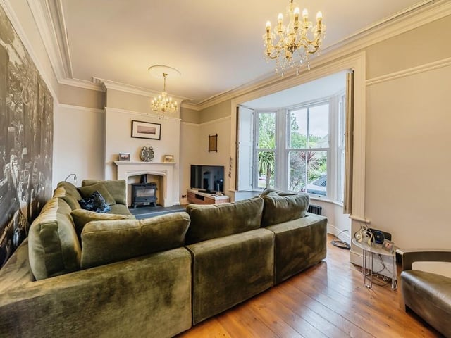The bay-fronted lounge, with feature fireplace and multi-fuel burner.