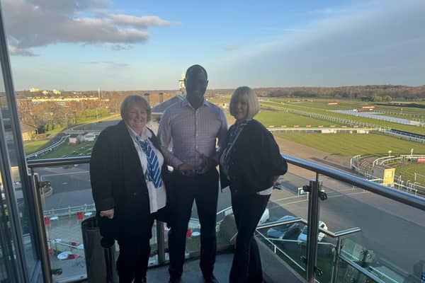 Yomi Eletu with his award and Care Manager Alison Springall (right) and Care Coordinator Michele Mullins (left).