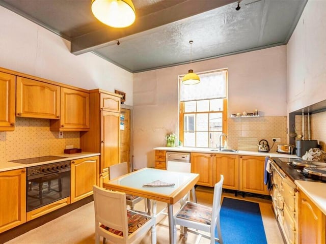 The breakfast kitchen has a range of fitted units and an oil-fired Aga.