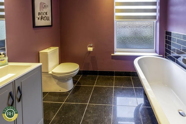 A bathroom with free-standing bath and washbasin vanity unit.