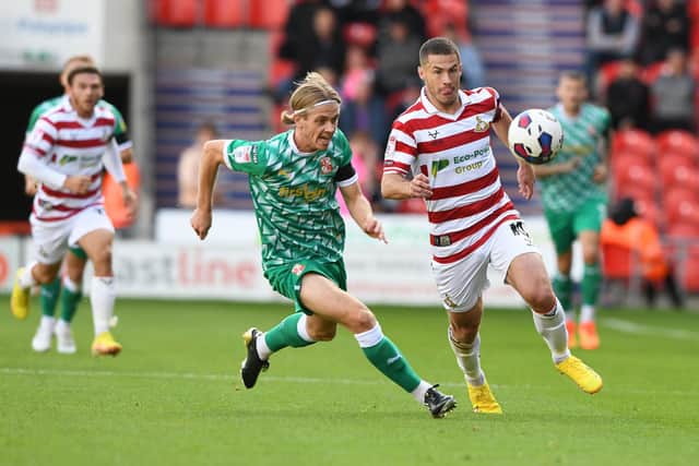 Doncaster's Tommy Rowe chases a through ball.