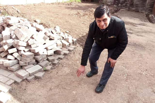 Mohammad Afzal shows the spot where a digger dug up a bomb in his garden in Intake, Doncaster