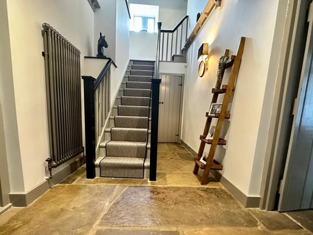 The entrance hall has a cloakroom off, and staircase leading up.