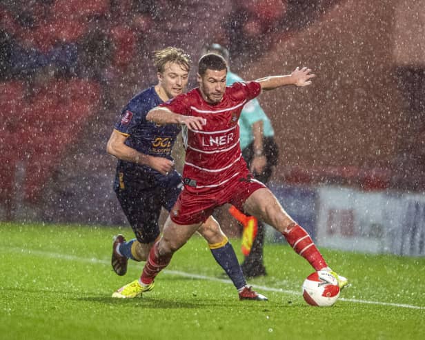 Tommy Rowe takes the ball on with George Lapslie in pursuit.