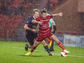 Tommy Rowe takes the ball on with George Lapslie in pursuit.