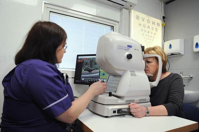 Specialist Wet AMD nurse Lynn Ford examines a patient's eyes