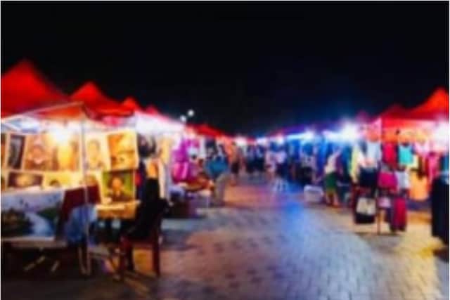The event was advertised with this picture of a string of brightly lit market stalls.