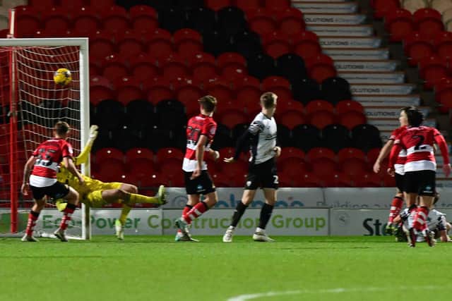 Doncaster's keeper Louis Jones is beaten by Morecambe's Michael Mellon for his sides fifth goal. (Picture:Andrew Roe/AHPIX LTD)