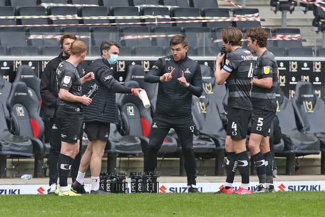 Andy Butler gives instructions to his players at MK Dons