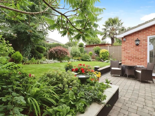 An established and private rear garden with a patio seating area.