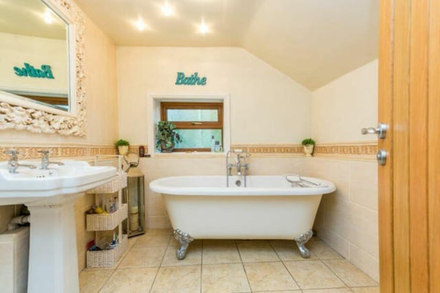 A free-standing, claw foot bath features in this house bathroom.