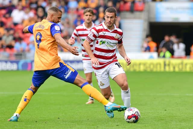Tommy Rowe plays a pass against Mansfield Town.