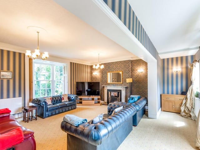 A stunning sitting room that looks out over the garden.
