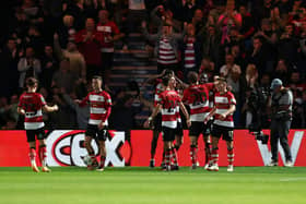 Joe Ironside of Doncaster Rovers celebrates with his teammates after scoring the team's first goal  during the Carabao Cup Second Round match between Doncaster Rovers and Everton at Keepmoat Stadium on August 30, 2023 in Doncaster, England. (Photo by George Wood/Getty Images)