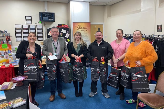 Jane Betts, Mexborough Slimming World Manager and Sean Gibbons, Mexborough Foodbank Manager, collecting the Easter donation with other Mexborough Slimming World members.