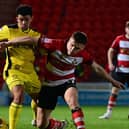 Doncaster Rovers' Owen Bailey battles for the ball against Burton Albion in the Bristol Street Motors Trophy.