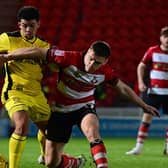 Doncaster Rovers' Owen Bailey battles for the ball against Burton Albion in the Bristol Street Motors Trophy.