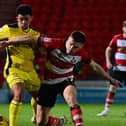 Doncaster Rovers' Owen Bailey battles for the ball against Burton Albion in the Bristol Street Motors Trophy.