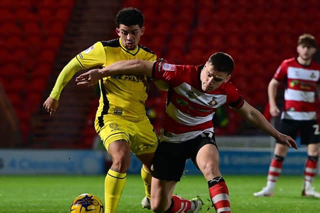 Doncaster Rovers' Owen Bailey battles for the ball against Burton Albion in the Bristol Street Motors Trophy.