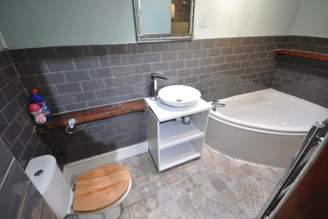 This bathroom features a corner bath and separate shower cubicle.