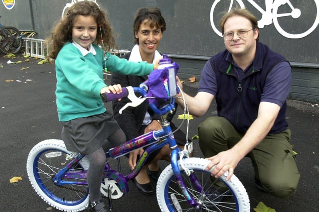 Pictured at JE James Cycles, Bramall Lane, Sheffield, where  manager Gavin Holliday, and Sharon Bagshaw from Sports and Community Recreation are seen presenting a bike to Caroline Raynor, age five, winner of the Council's Joke competition, as part of the Go For It 2002 summer playscheme.