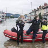 A resident of Yarborough Terrace in Doncaster is helped from a boat after being taken from her home as flood waters rise from the River Don