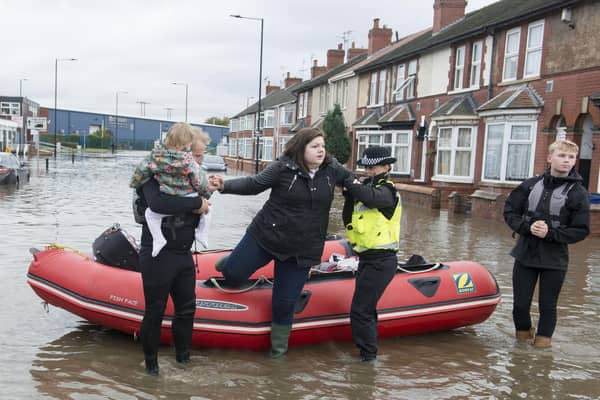 A resident of Yarborough Terrace in Doncaster is helped from a boat after being taken from her home as flood waters rise from the River Don