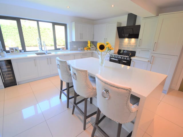 The kitchen is newly refurbished, and boasts dove grey shaker style walls and base units with contrasting work surfaces. Appliances included a built in fridge and freezer, built in dishwasher, wine cooler, Smeg oven with induction hob and more.
