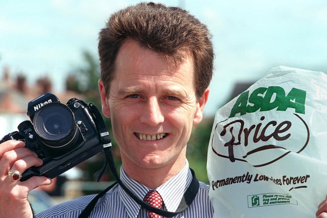 John Rowlands, general store manager for Asda at Carcroft, Doncaster taking pictures of Asda shopping bags while on holiday in 1999
