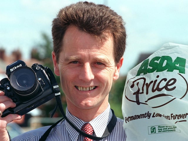 John Rowlands, general store manager for Asda at Carcroft, Doncaster taking pictures of Asda shopping bags while on holiday in 1999