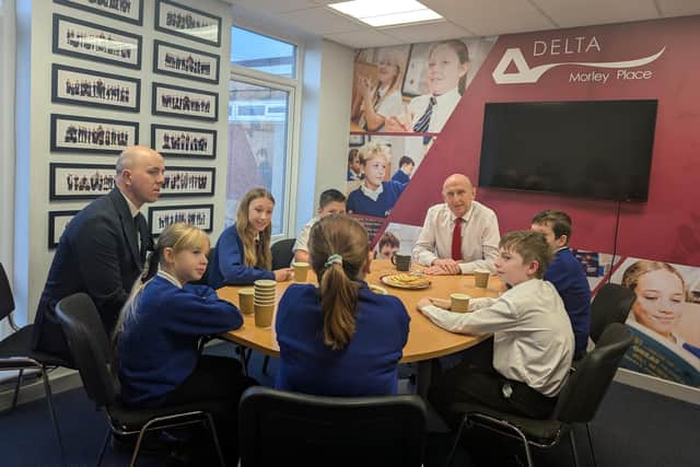 John Healey MP speaks with pupils.