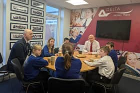 John Healey MP speaks with pupils.