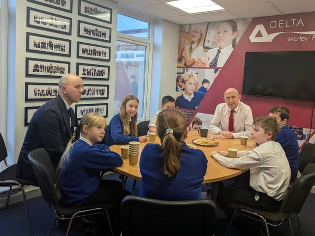 John Healey MP speaks with pupils.
