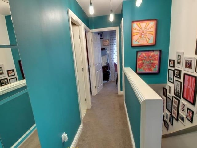 The first floor landing leads to three bedrooms and a modern bathroom.