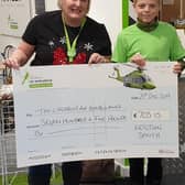 Kristian handing over his initial fundraising to the Children’s Air Ambulance