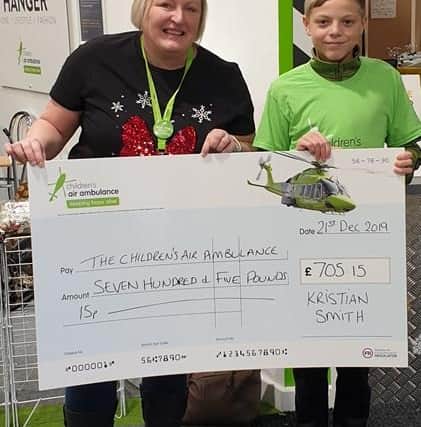 Kristian handing over his initial fundraising to the Children’s Air Ambulance