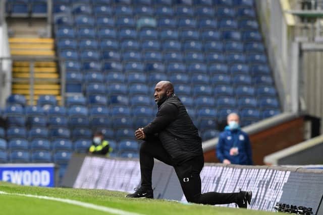 Darren Moore takes the knee