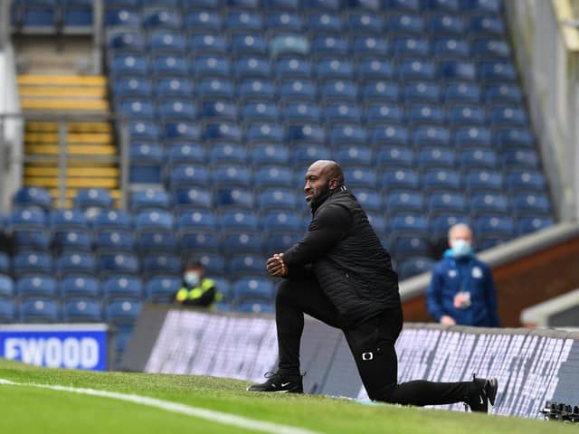 Darren Moore takes the knee