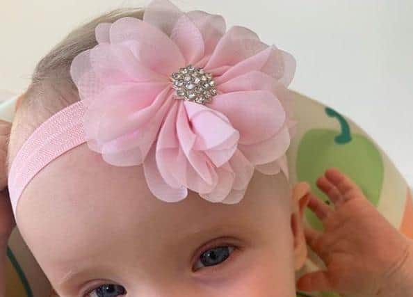 Baby Elizabeth in a hair accessory made by Sammy Booth.