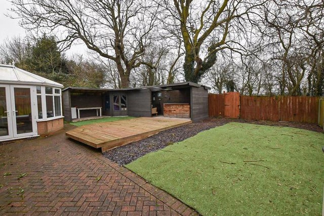 As we say farewell to the South Normanton house, take a look at the large and enclosed back garden. The conservatory is to the left, the bar and 'gin snug', with a decked seating area, is in the centre, and a lawn of artifical turf to the right.