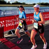 Teresa and friend Michelle sharing the finish line at the Triathlon Relay in Nottingham.