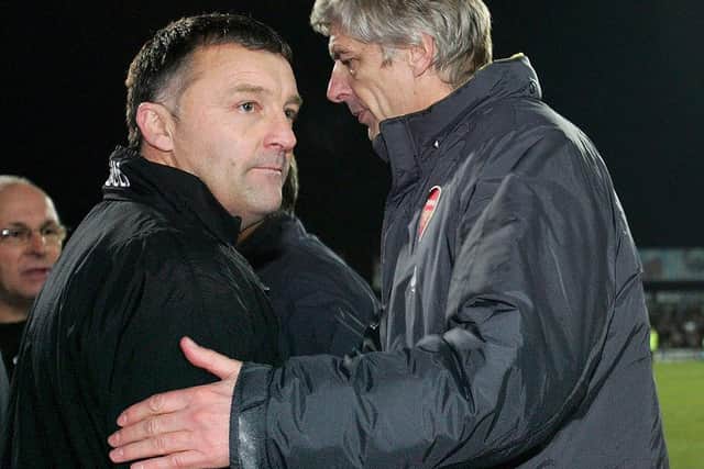 Dave Penney shakes hands with Arsene Wenger. Photo: Ross Kinnaird/Getty Images