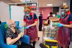 A nurse prepares to administer the Pfizer-BioNTech COVID-19 vaccine to patient Trixie Walker at the Northern General Hospital in Sheffield (Photo by ANDY STENNING/POOL/AFP via Getty Images)