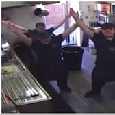 Staff at Harry's fish bar stage their impromptu dance routine while cleaning up.