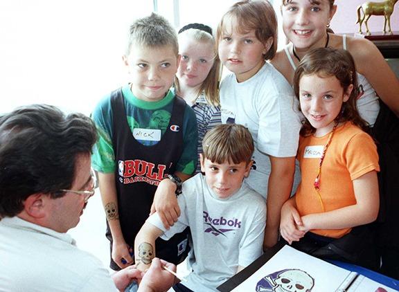 9-years-old Karl Potts gets the tattoo treatment from Richard Mario at Richmond Hill School, Sprotborough, as part of a playscheme.... August 17, 1998